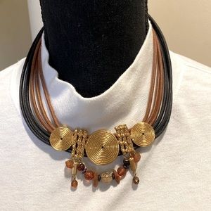Gold colored leather and beaded necklace with gold medallions.